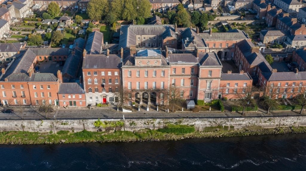 Brick_buildings_along_riverbank_202608031443