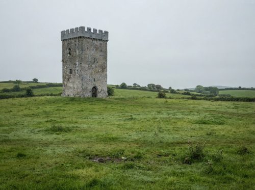 Figure_walking_near_ancient_tower_202608160306