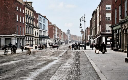 Historic reconstruction of George Street, Limerick, in 1900, showing shopfronts, street buildings and public activity.